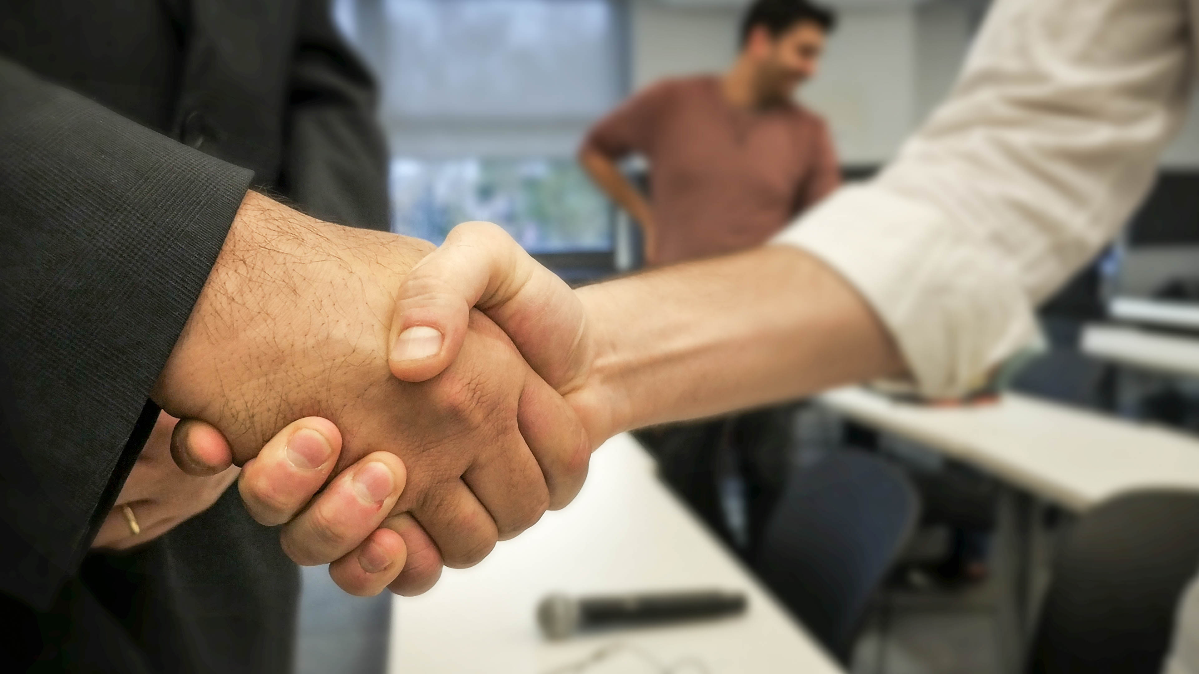 closeup of two men shaking hands