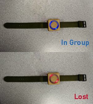 Mynd prototype wristwatches: top watch is flashing blue light to indicate "In-Group" and bottom watch is flashing red light to indicate "Lost"