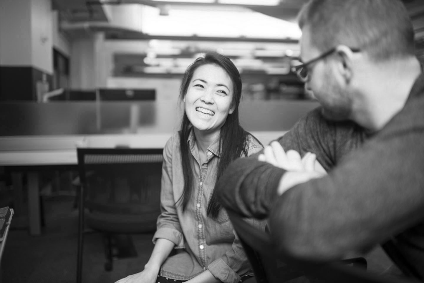 A woman smiling at a man.