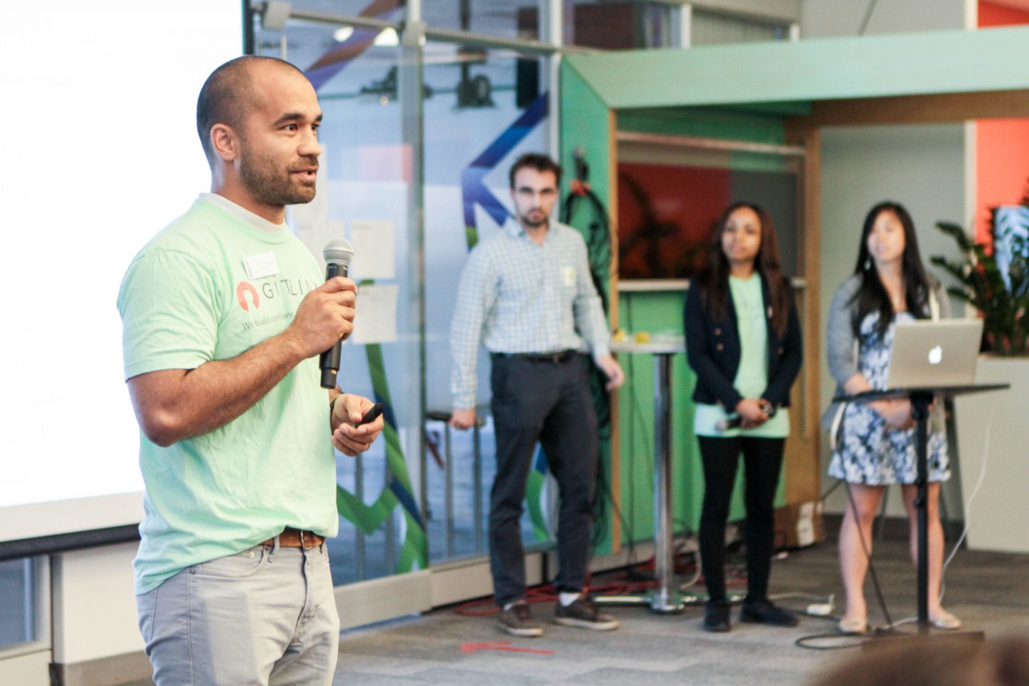 Student holding a microphone and giving a presentation