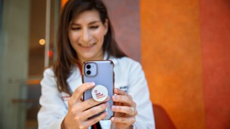 Dr. Madeline Sterling ’08, assistant professor of medicine at Weill Cornell Medicine, talks with Yanick Pierre-Louis, her patient, on a video call.