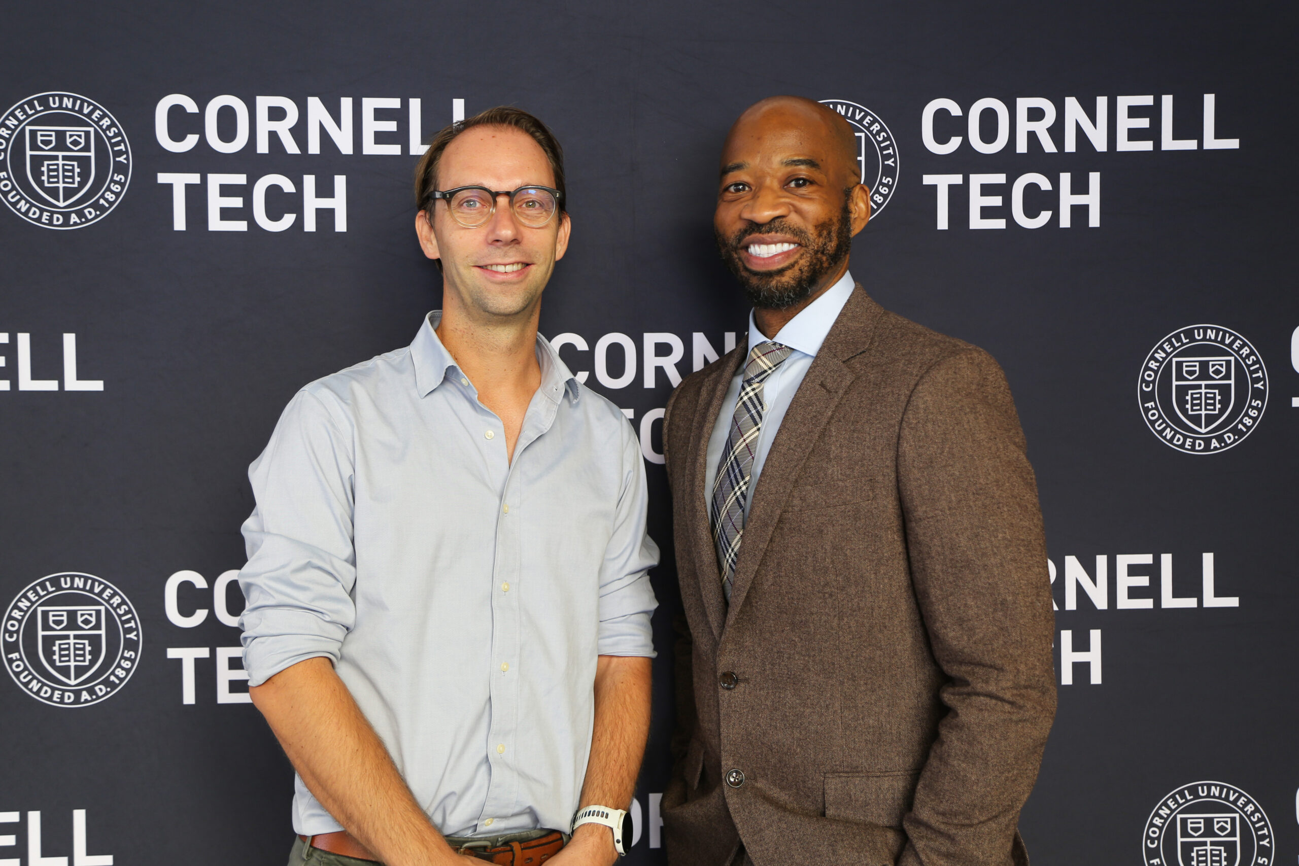 Thijs Roumen and Omari W. Keeles standing in front of a Cornell Tech banner background